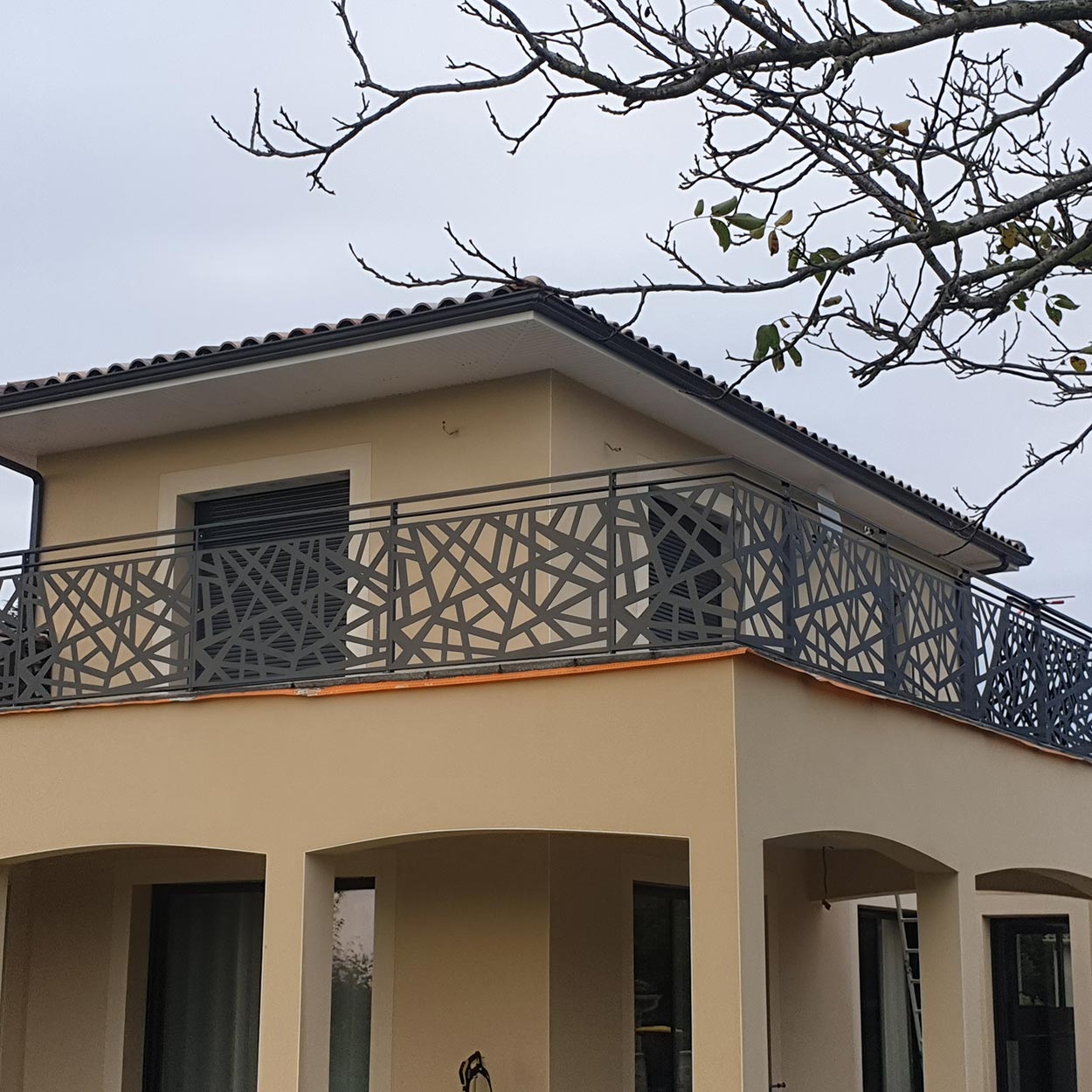Balcon d'une maison avec garde-corps à motif découpé